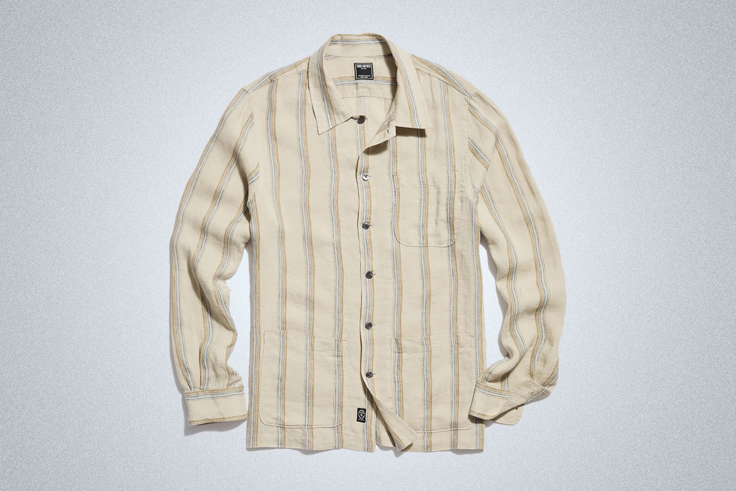 a linen tan long sleeve shirt from Todd Snyder on a grey background
