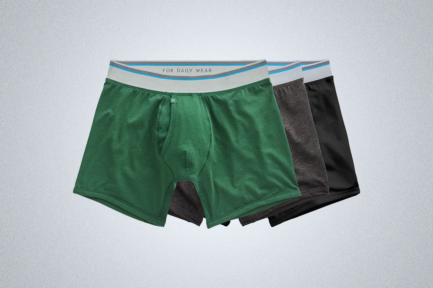 three pairs of underwear overlayed from Mack Weldon on a grey background