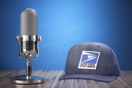 A desktop microphone and a US Postal Service hat