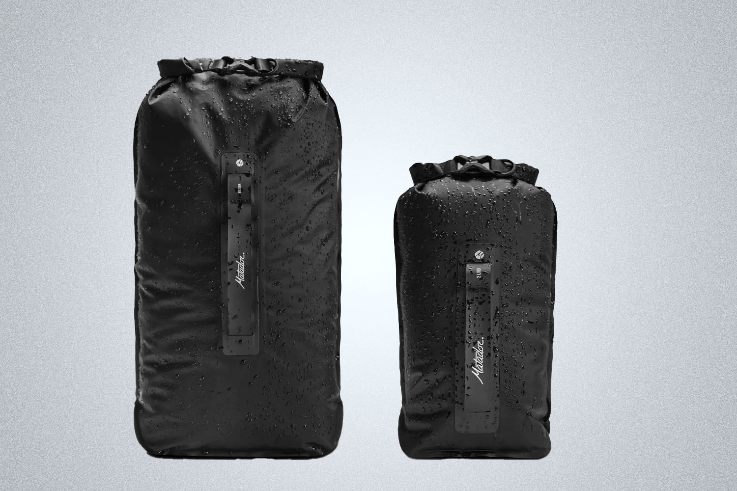 two black outdoor bags on a grey background