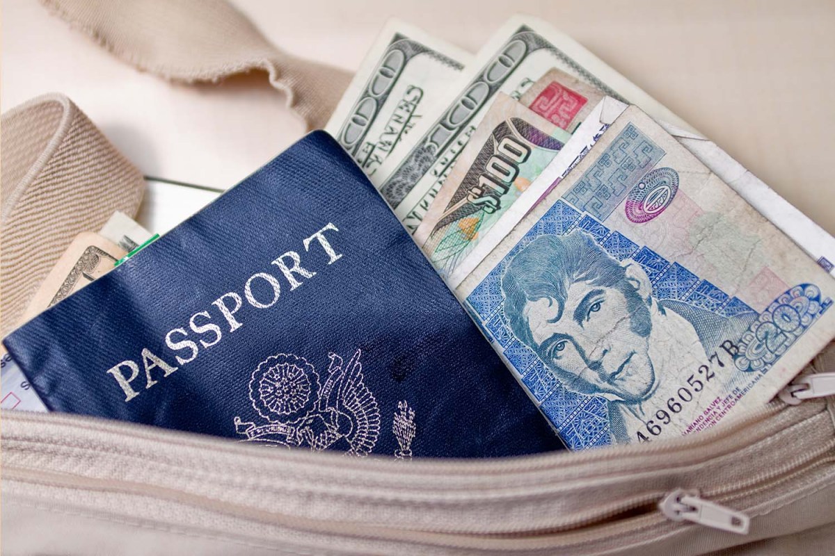 Passport arranged with currency in a money belt