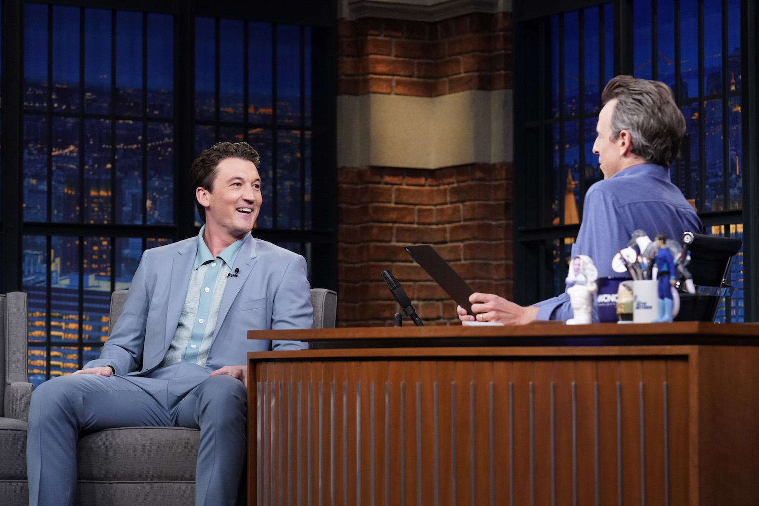 Miles Teller wearing a Todd Snyder polo on a late night show