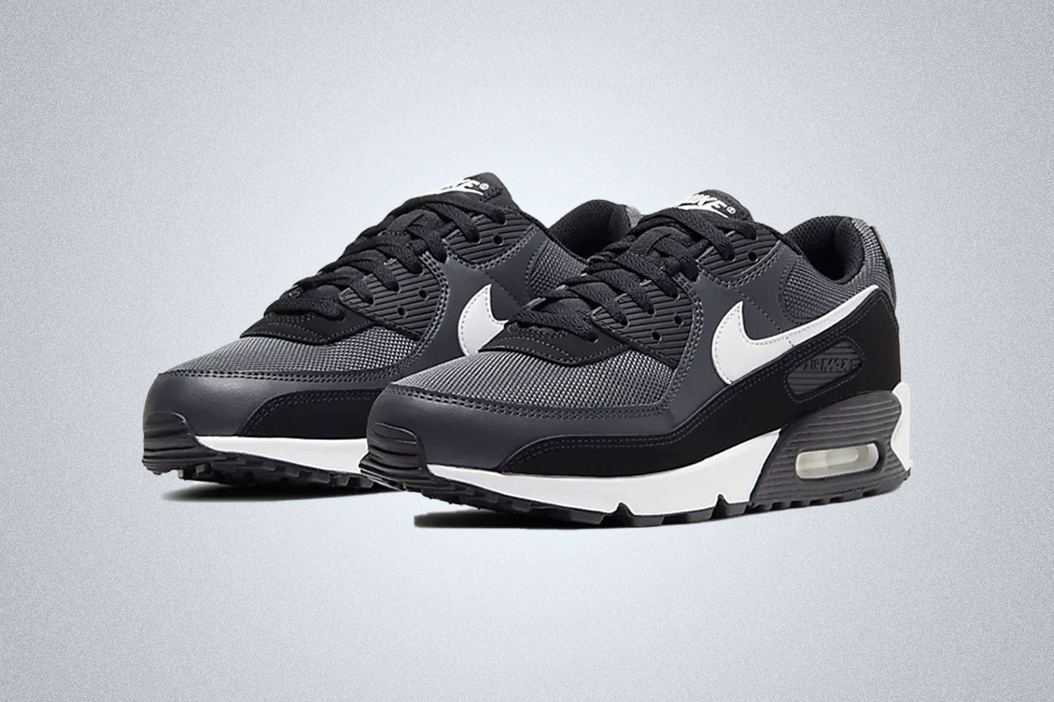 a black white and grey Nike Air Max 90 sneaker on a grey background