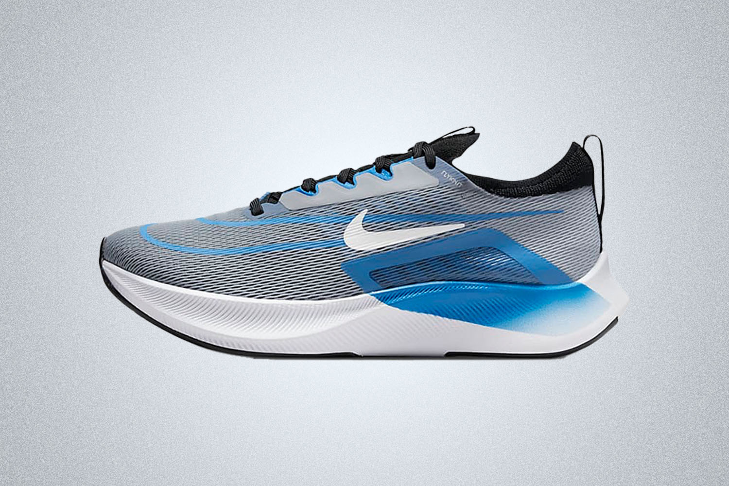 A blue and grey Nike running shoe on a grey background