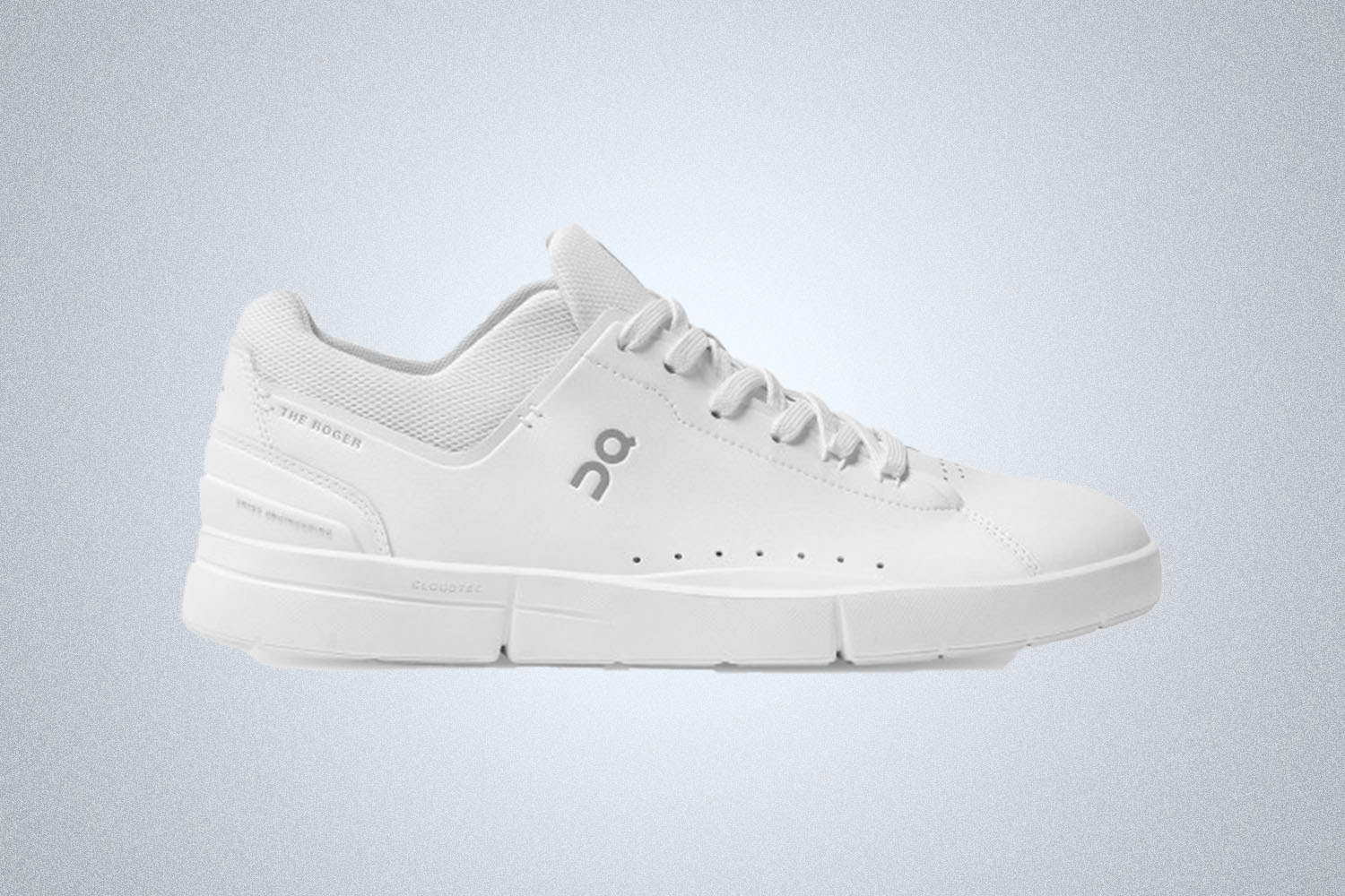 a pair of white On tennis shoes on a grey background