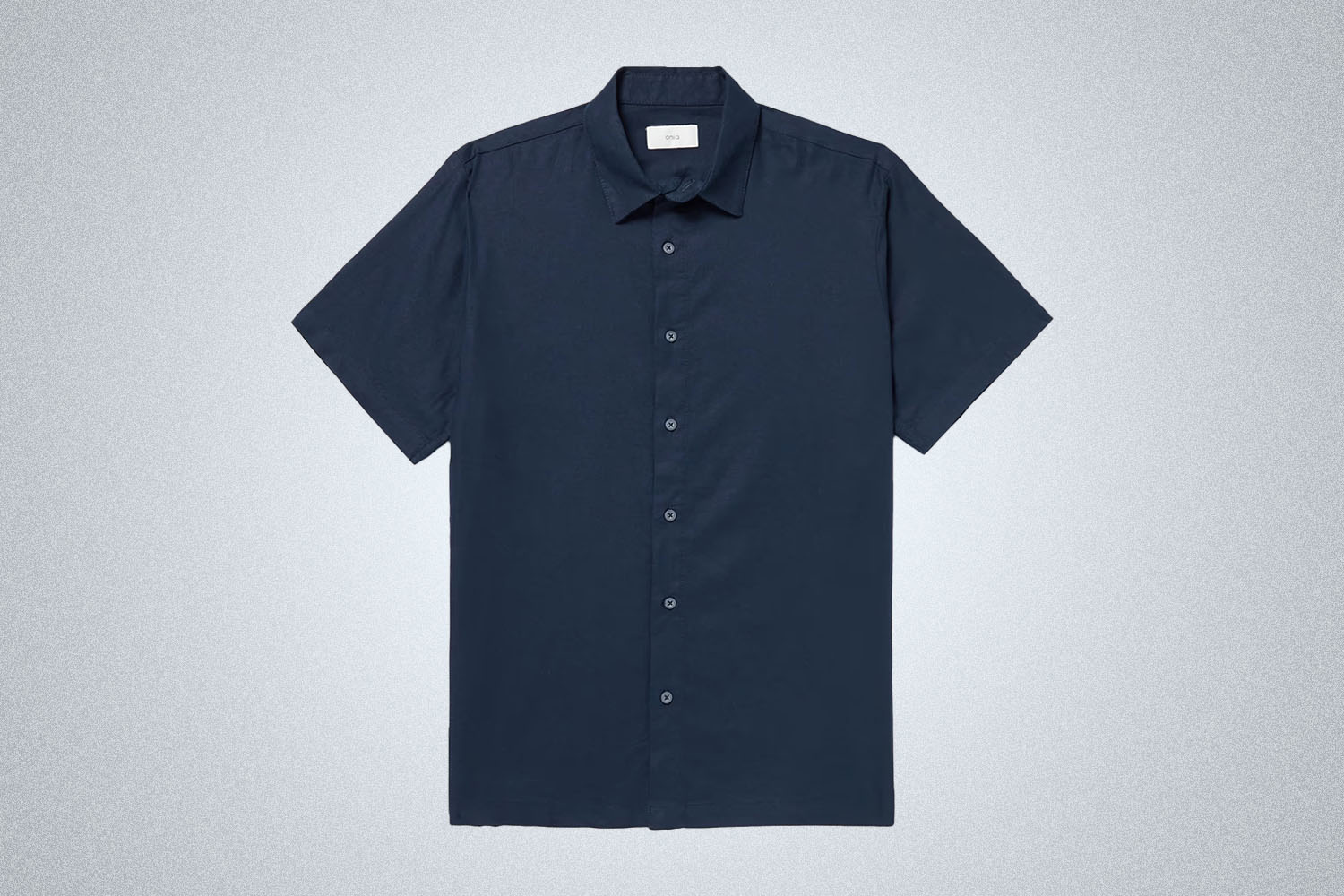 a navy blue linen button down from Onia on a grey background