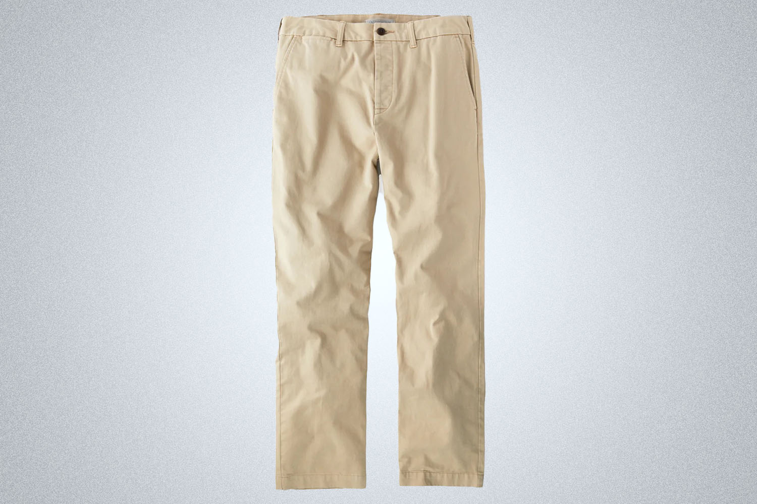 a pair of tan chinos from Outerknown on a grey background