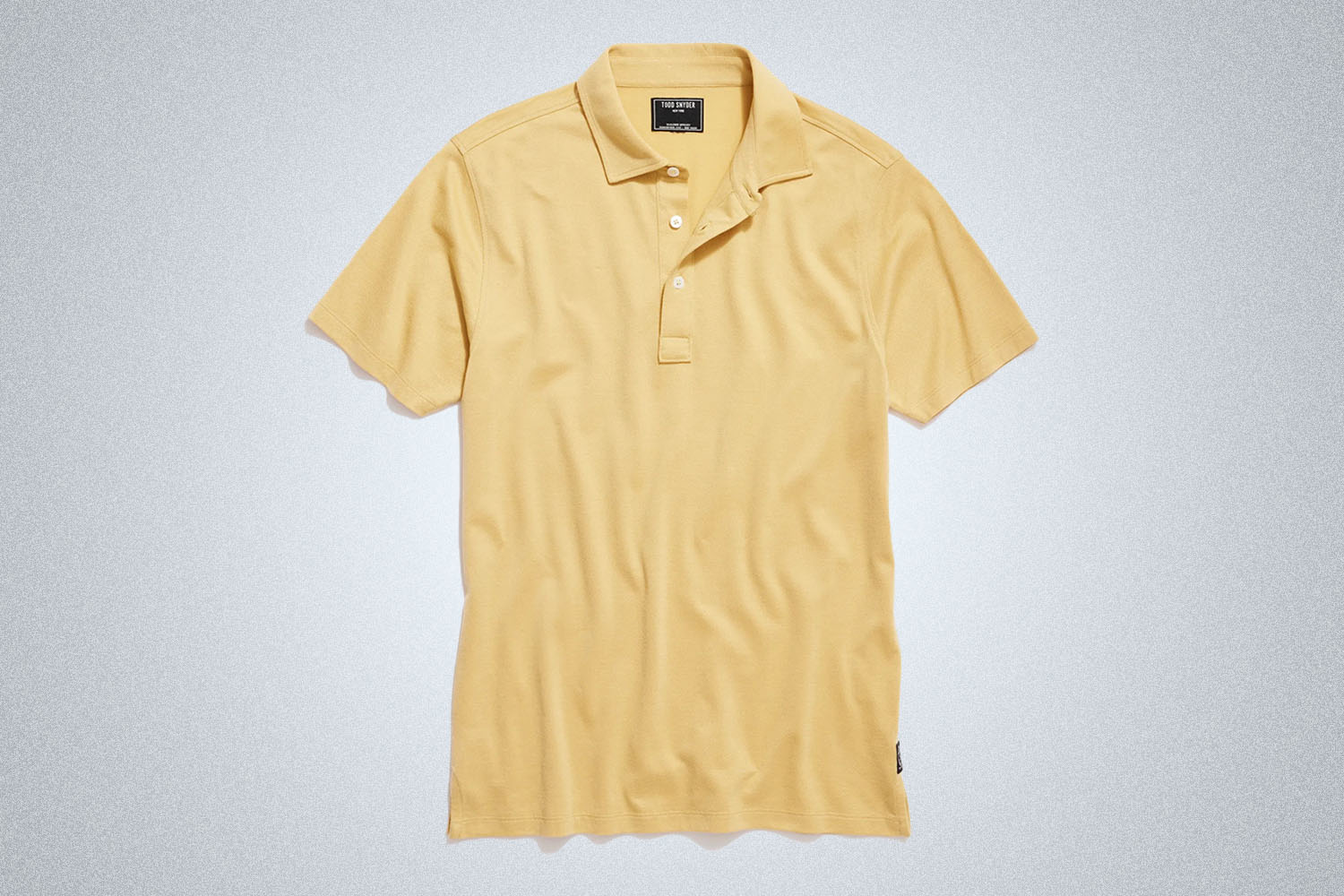 a yellow polo from Todd Snyder on a grey background