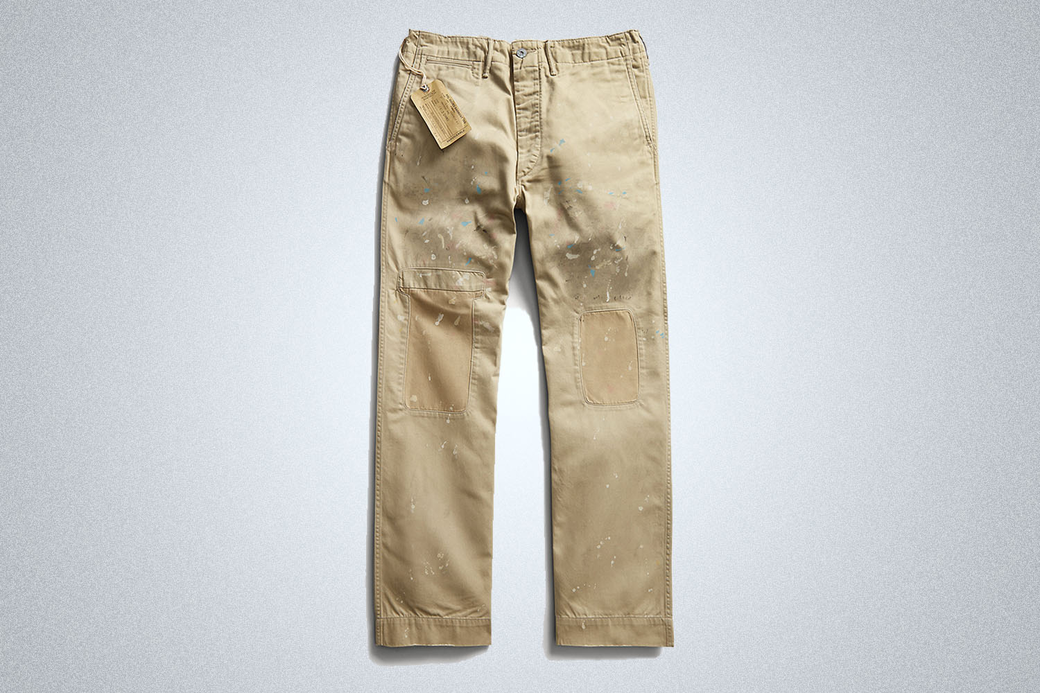 a pair of dirstressed chinos from RRL on a grey background