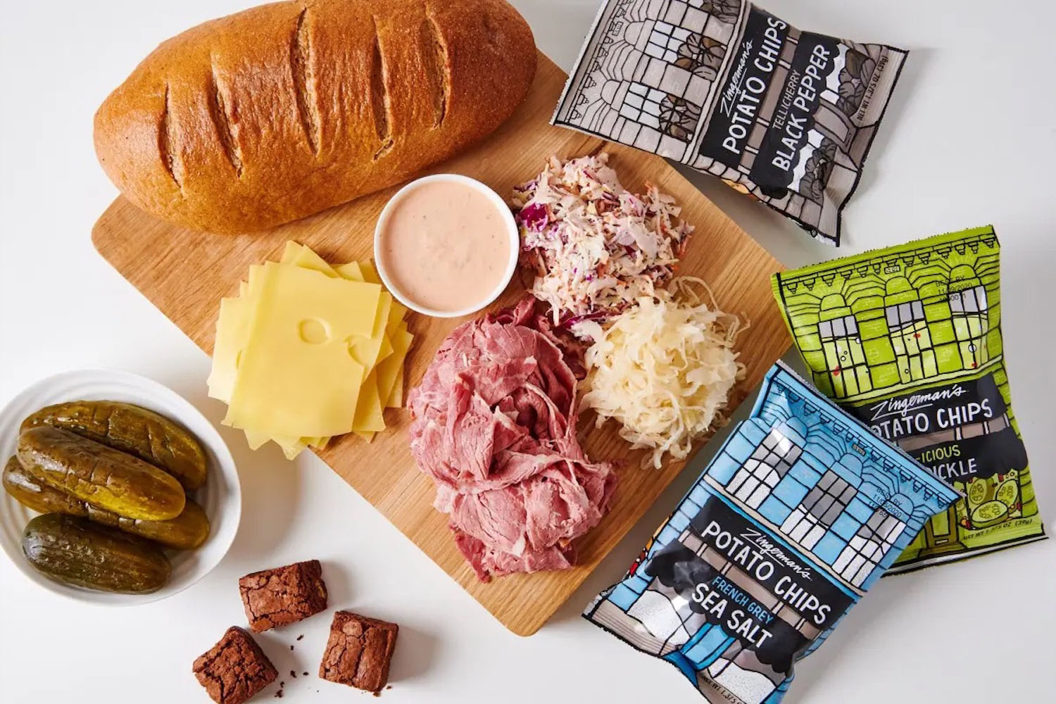 a collage of sandwich items on a white table from Zingerman's