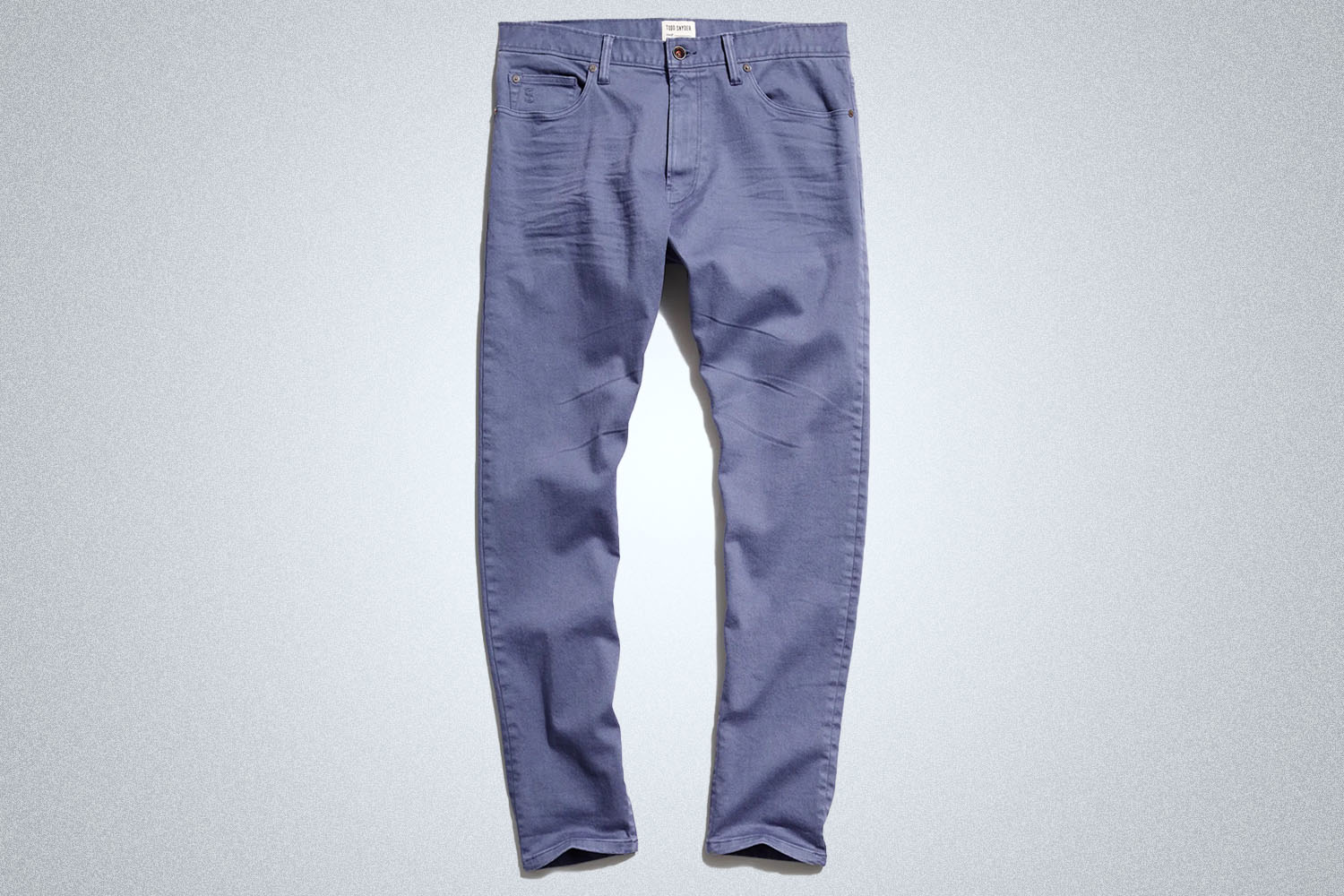 a pair of blue chinos from Todd Snyder on a grey background