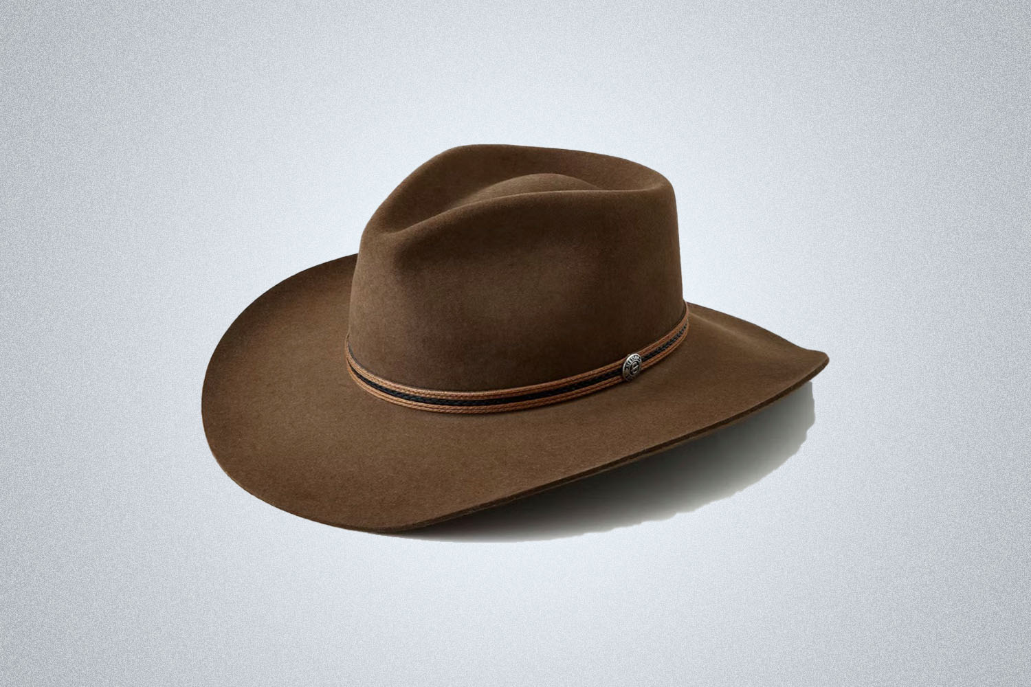 a stetson wide-brimmed cowboy hat on a grey background