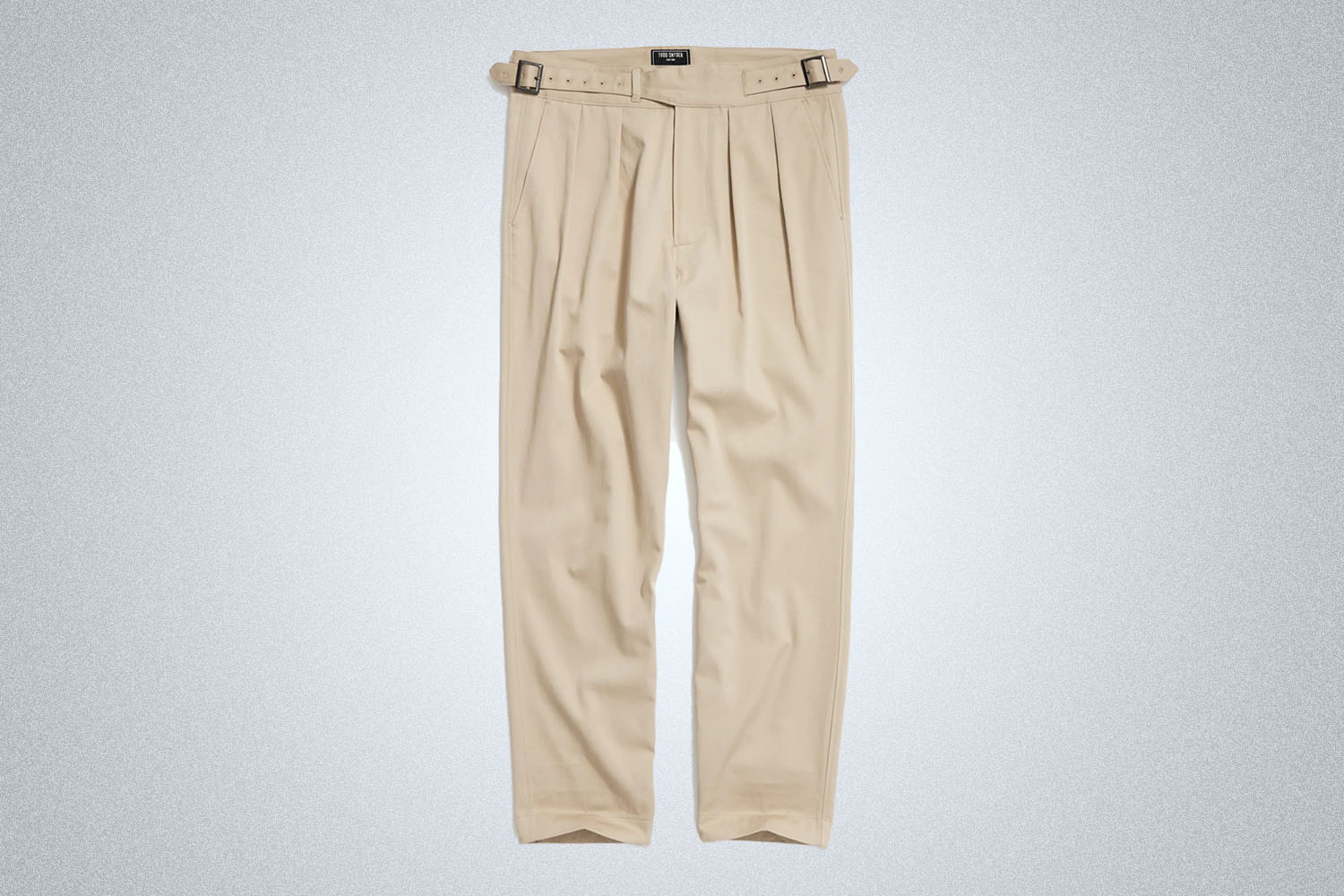 a pair of tan Gurkha pants from Todd Snyder on a grey background