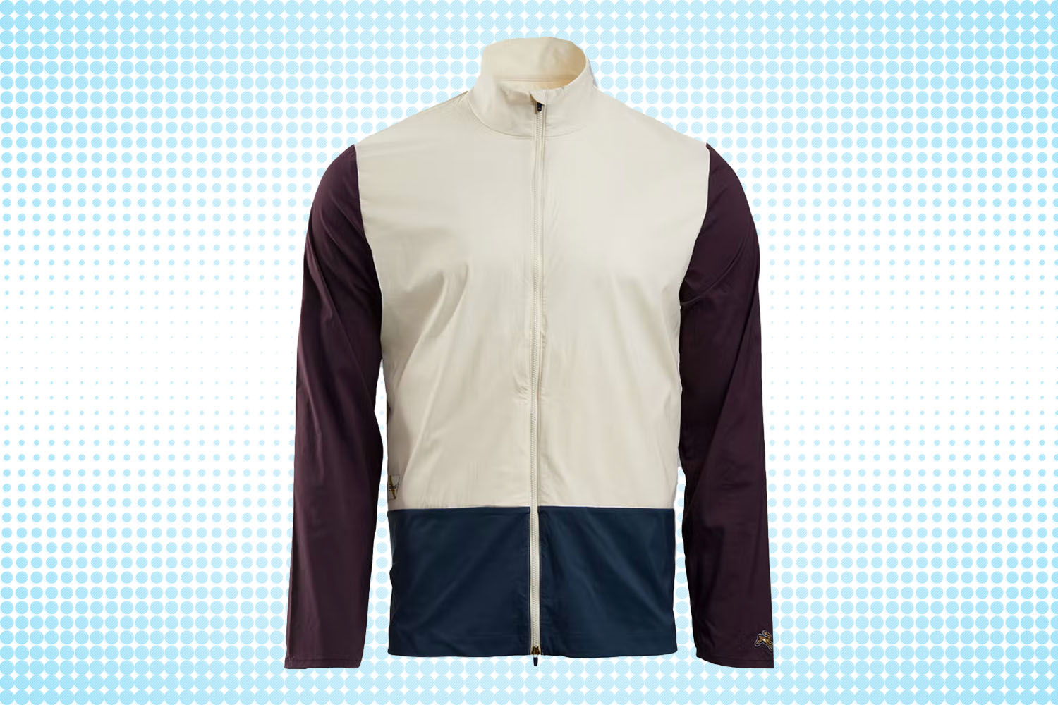 a tri-colored zip-up track jacket from Tracksmith on a white and blue dotted background