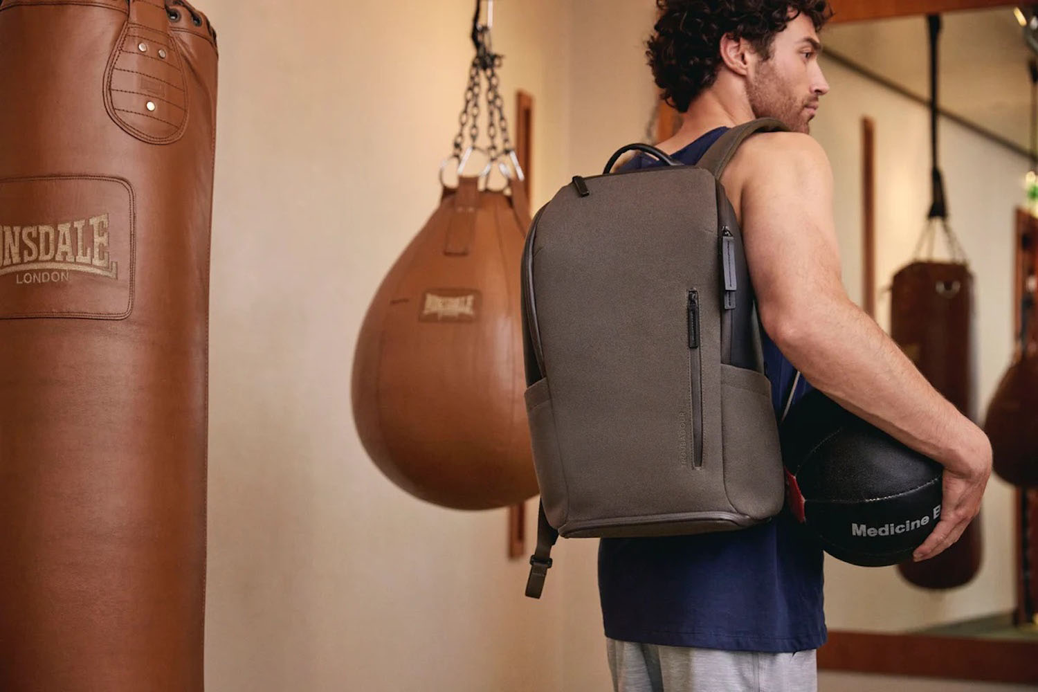 a model carrying a Troubadour bag from the new Khaki Collection in a boxing gym