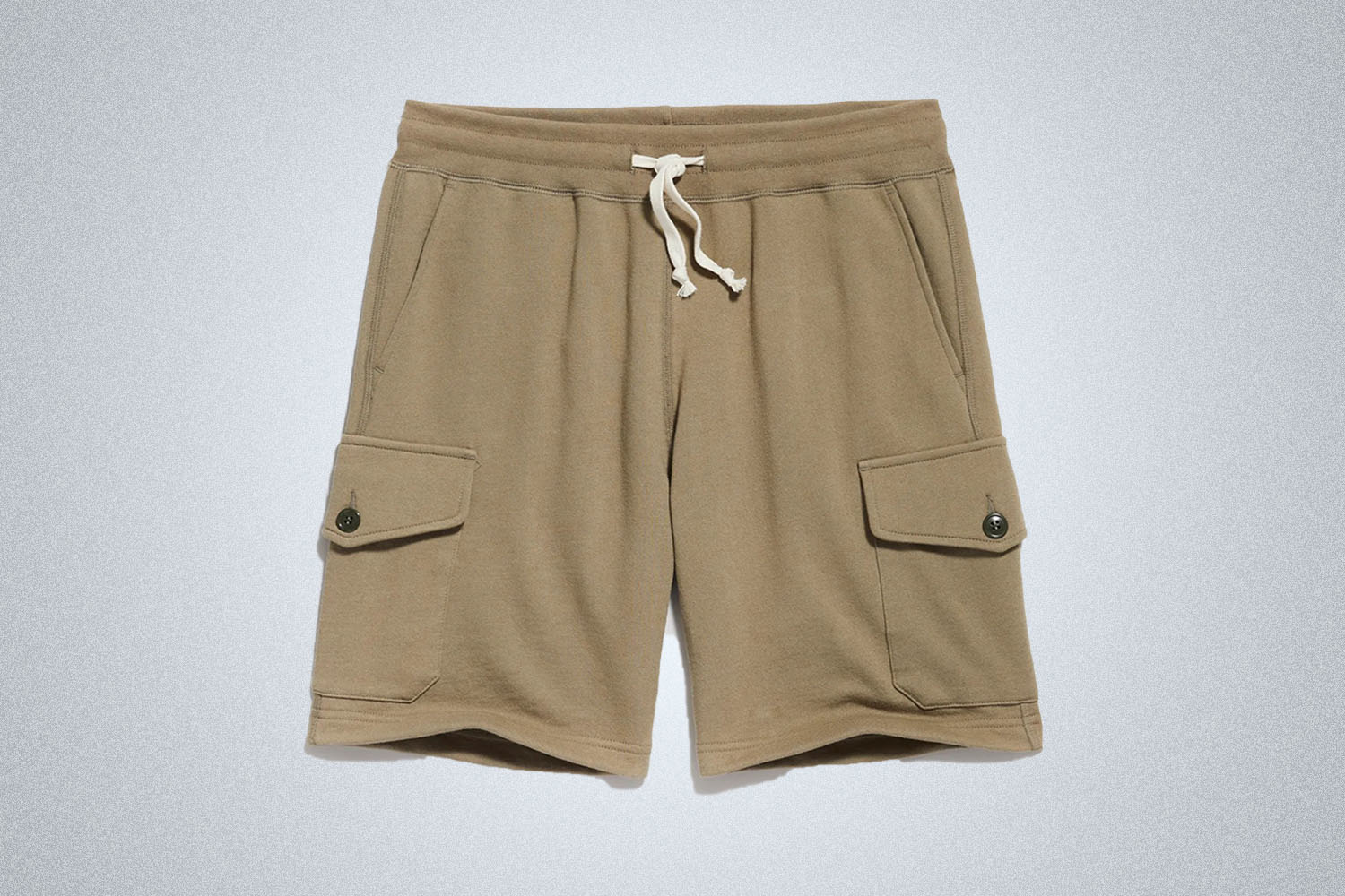 a pair of tan cargo shorts from Todd Snyder on a grey background