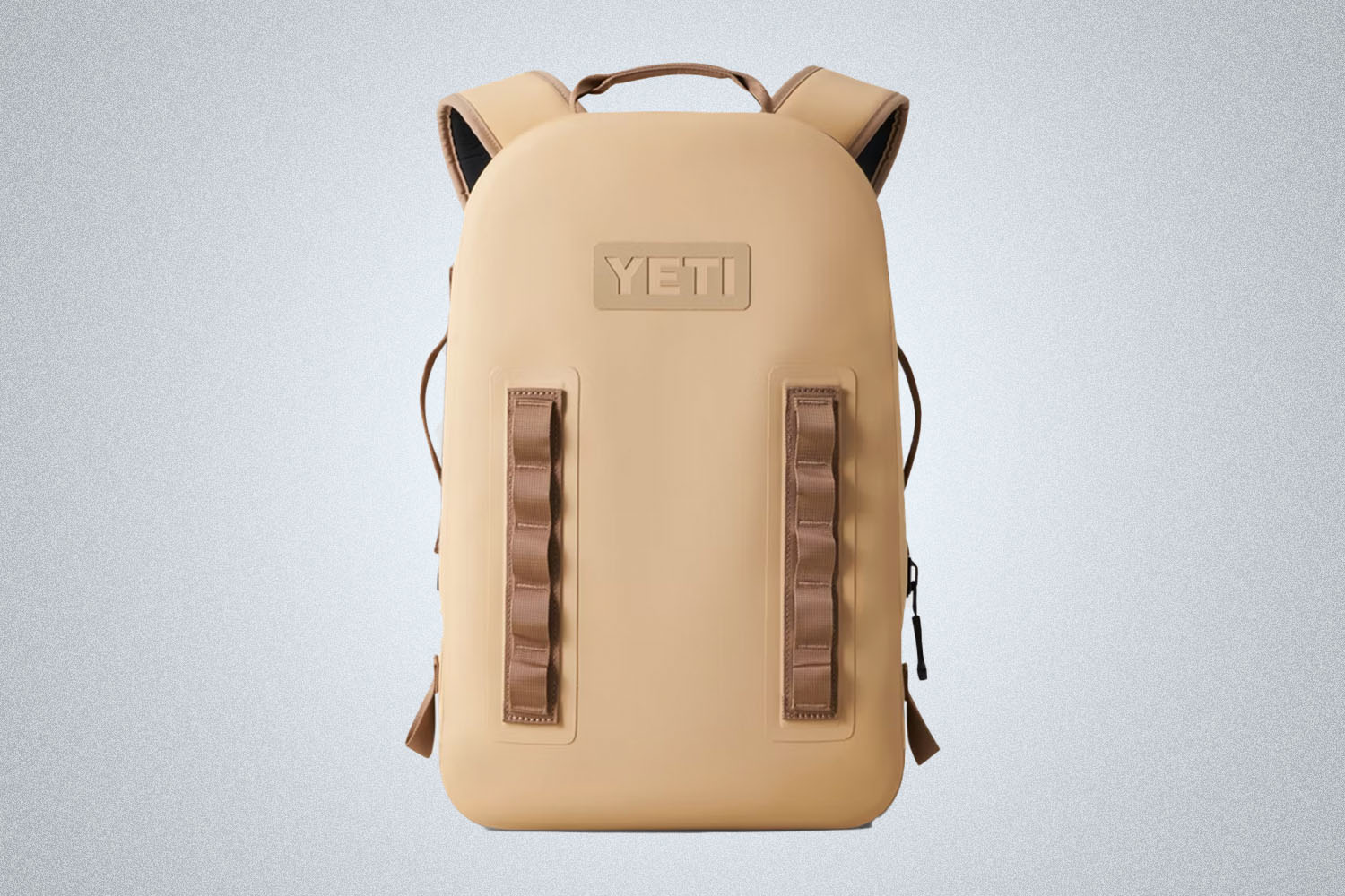 a beige YETI backpack on a grey background