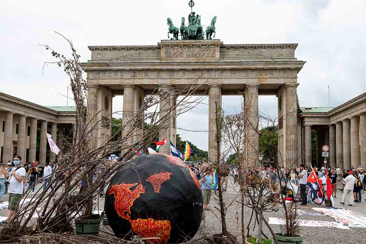 Activists of Extinction Rebellion demonstrate on "Global Earth Overshoot Day" with a symbolically "burning" globe in front of the Brandenburg Gate. The environmentalists drew attention to the day on which, according to their calculations, all renewable resources in the current year would be used up