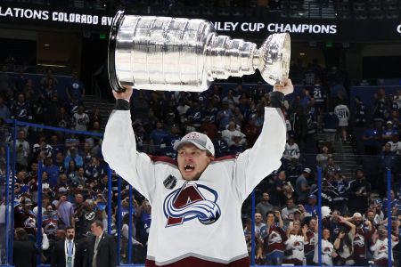 Erik Johnson of the Avalanche lifts the Stanley Cup in celebration