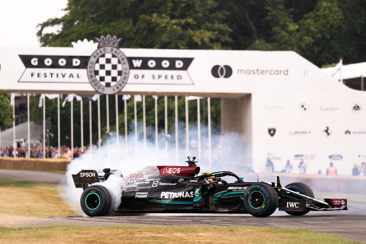An F1 car smokes its tires at the 2022 Goodwood Festival of Speed in England