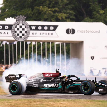 An F1 car smokes its tires at the 2022 Goodwood Festival of Speed in England