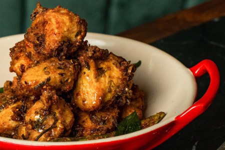 GupShup’s signature fried chicken in a white and red bowl. We got the recipe for the dish.