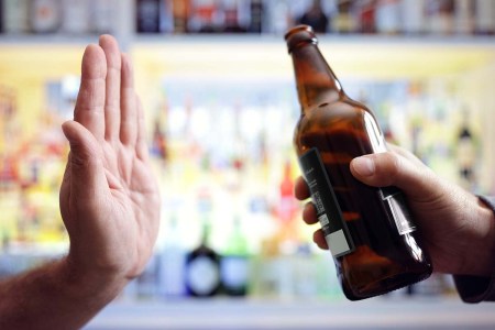 Hand rejecting beer in a bar. More Brits are choosing to try low and no alcohol options when visiting a pub