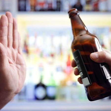 Hand rejecting beer in a bar. More Brits are choosing to try low and no alcohol options when visiting a pub