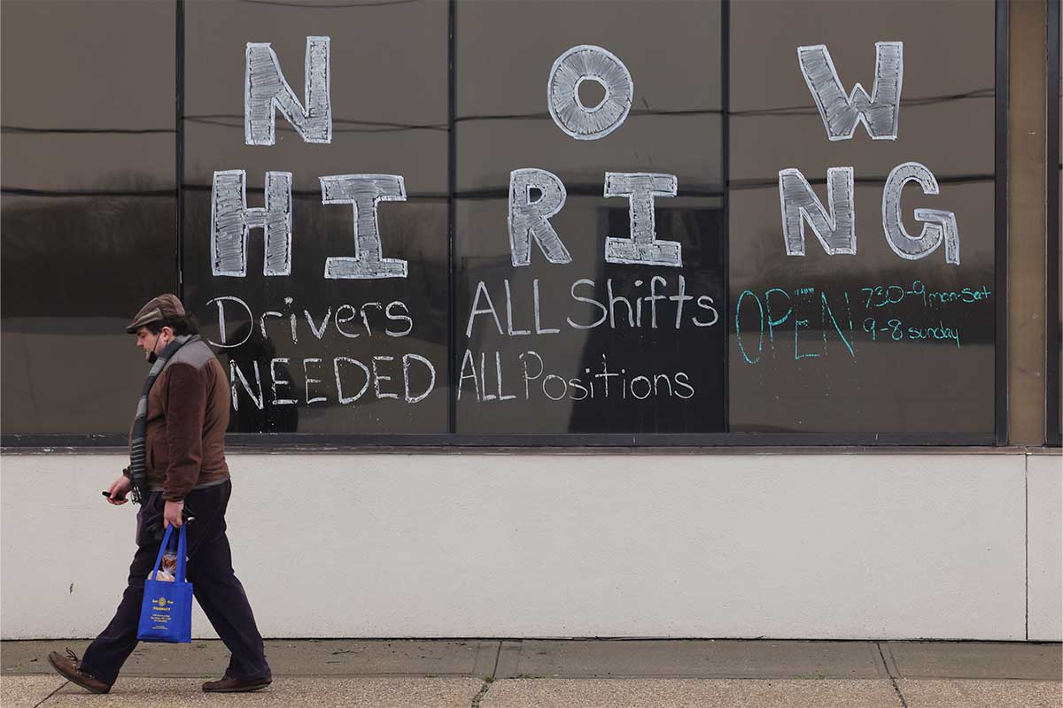 A large "Now Hiring" advertisement posted on the windows of the Advance Auto Parts store in Bay Shore, New York on March 24, 2022