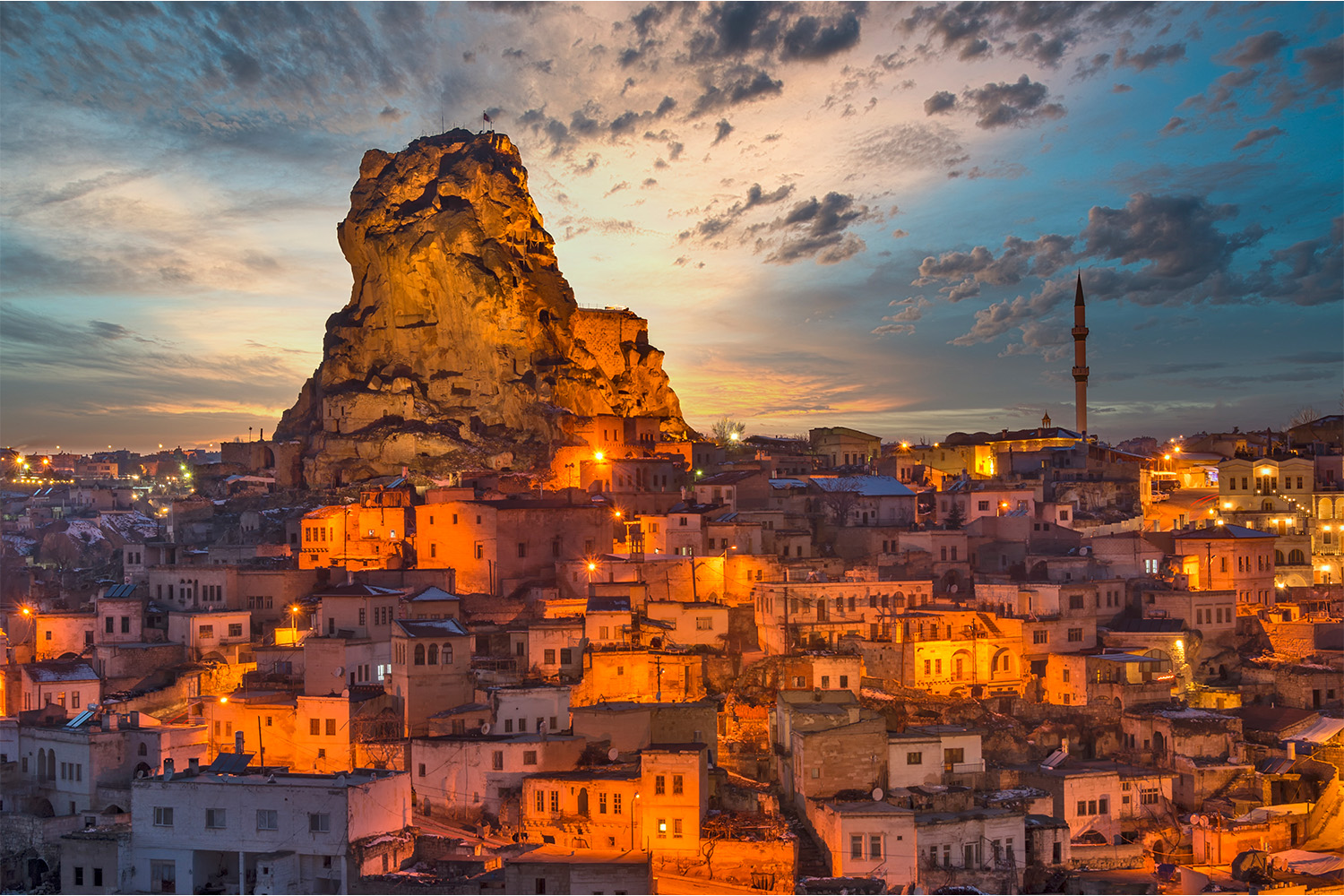 Sunset over Ortahisar village and fortress in Cappadocia.