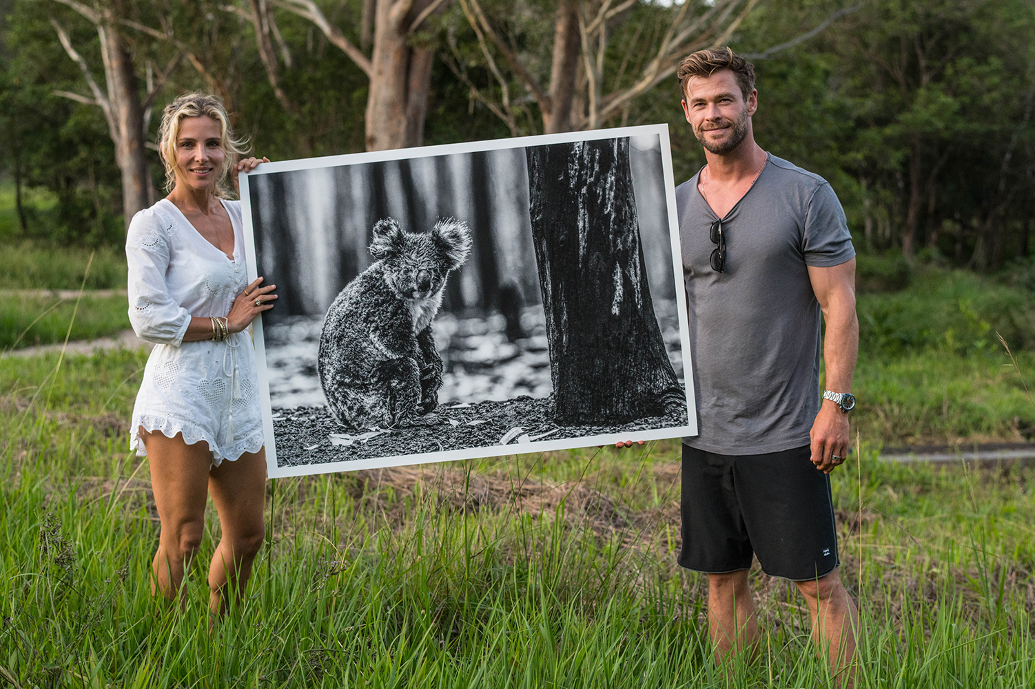 Elsa Pataky and husband Chris Hemsworth with David Yarrow’s photo “Survivor,” of a lone koala, which helped raise money for Australian wildfire recovery.