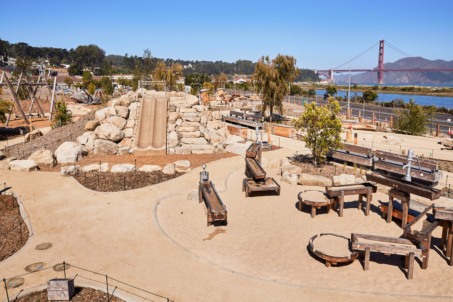A playground at the new Tunnel Tops park in San Francisco with the Golden Gate Bridge in the background