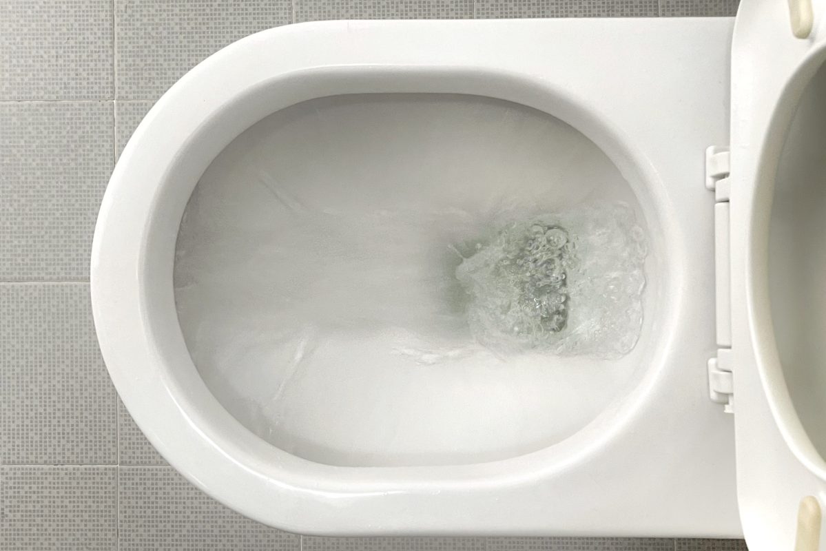 Water flushing down a toilet bowl