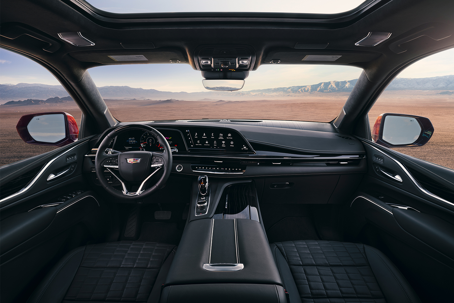 The generous interior of the 2023 Cadillac Escalade-V, showing the front two seats and the dashboard