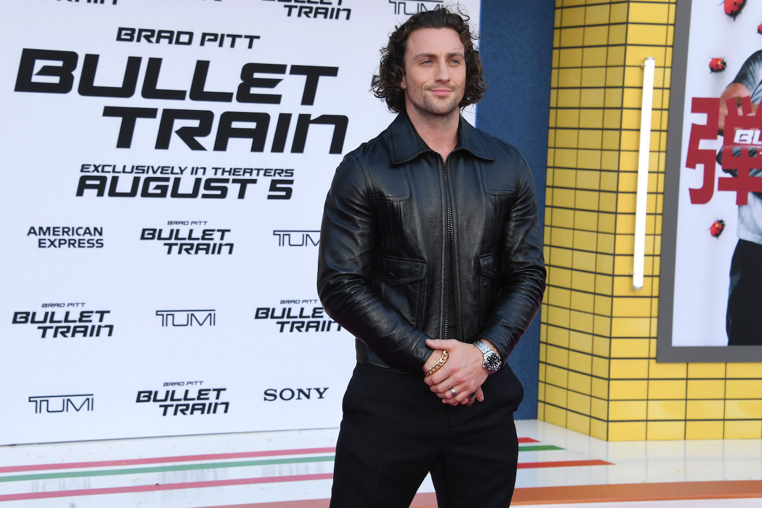 a photo of Aaron Tyler Johnson in a black leather jacket during the premier of Bullet Train
