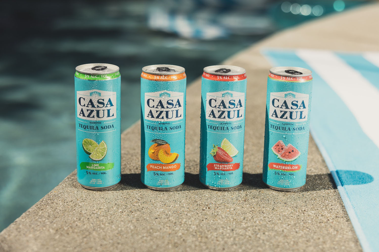 a few bottles of Casa Azul next to a pool