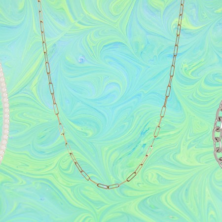 a collage of necklaces and chains on a marbled green and blue background