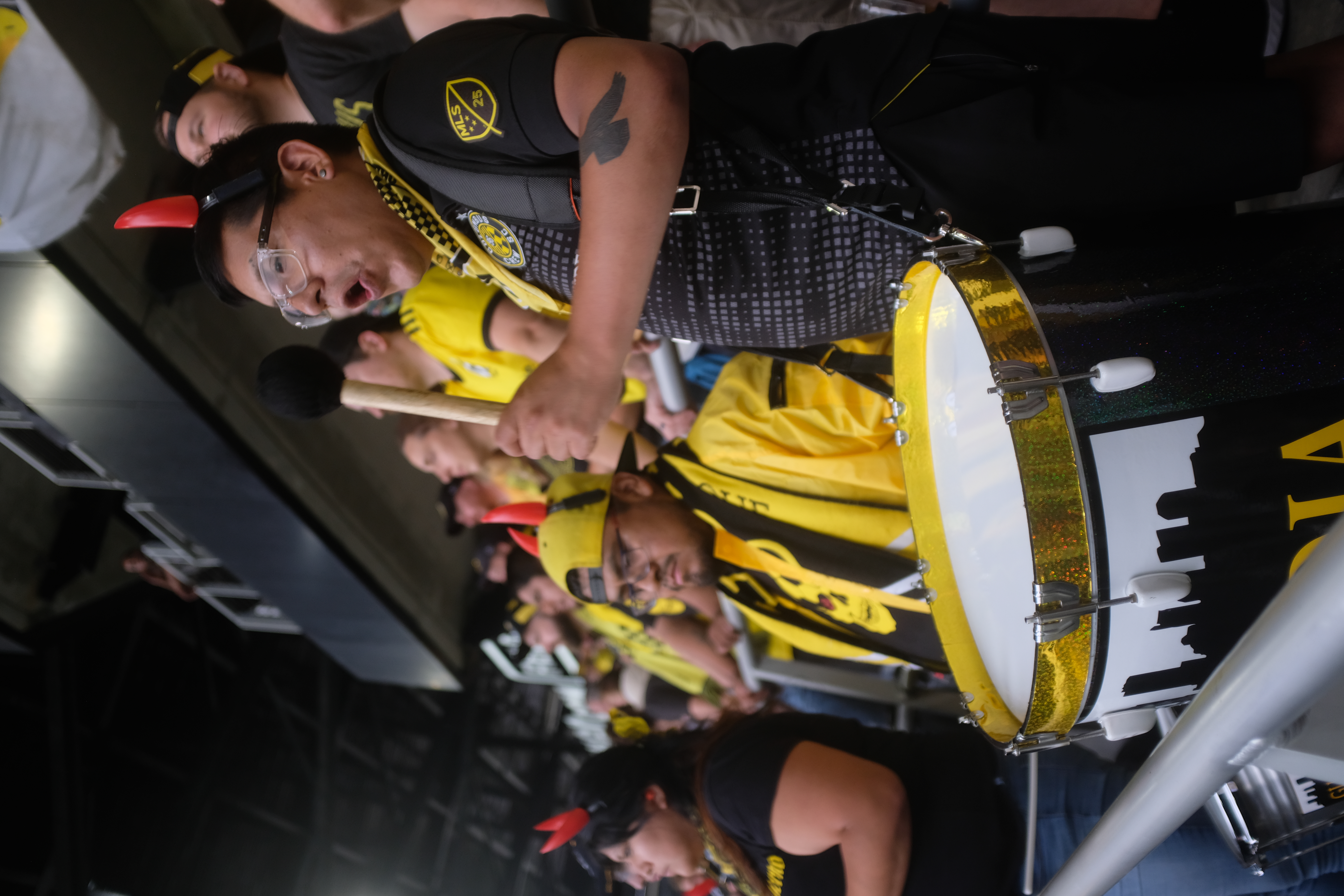Members of The Nordecke bang drums at a Crew match,