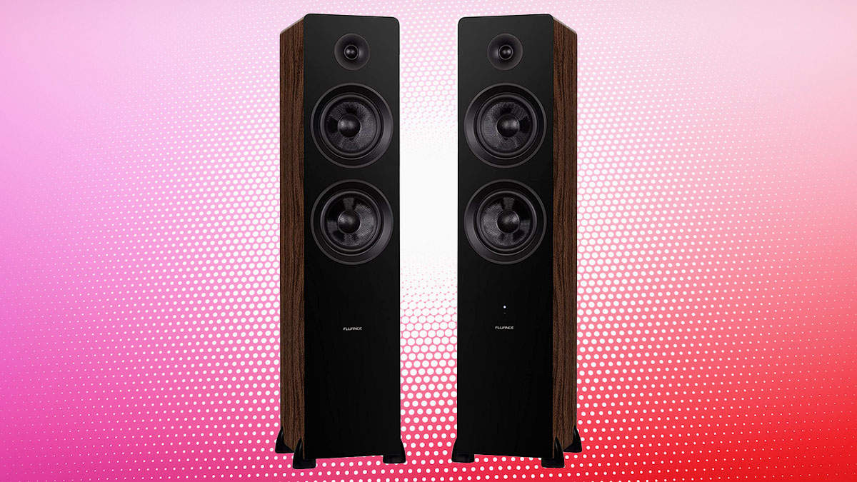 A pair of black and walnut ai81 standing tower speakers from Fluance on a multi-colored red and pink dot background