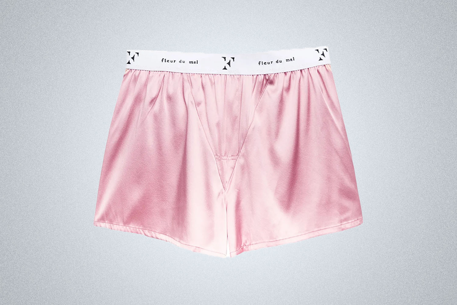 a pair of pink Fluer De Mal silk boxers on a grey background