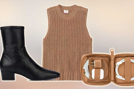 A black boot, brown sweater tank and brown tech organizer
