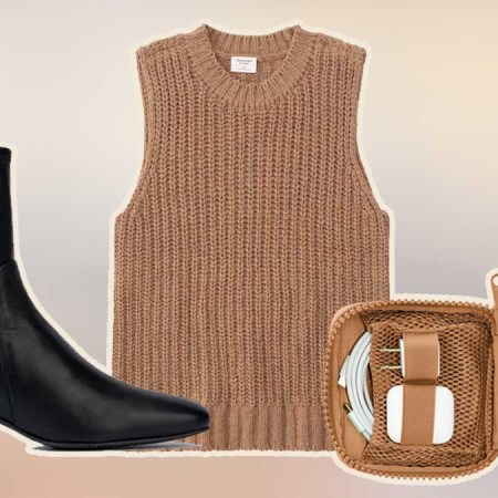 A black boot, brown sweater tank and brown tech organizer