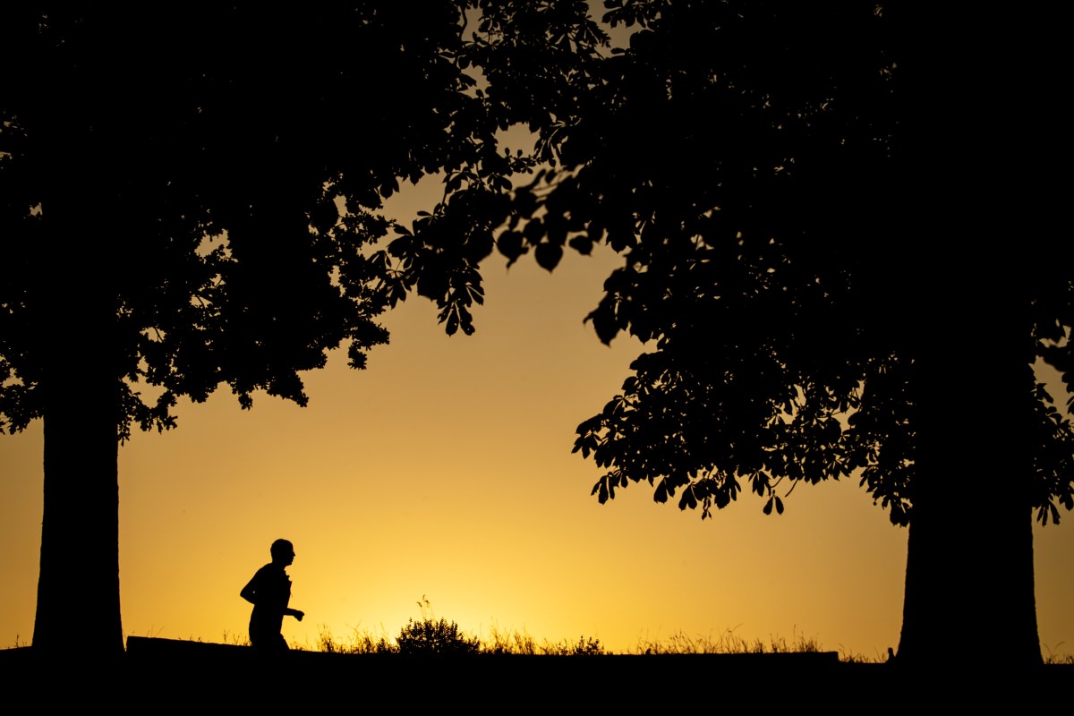 A jogger in front of sunrise.