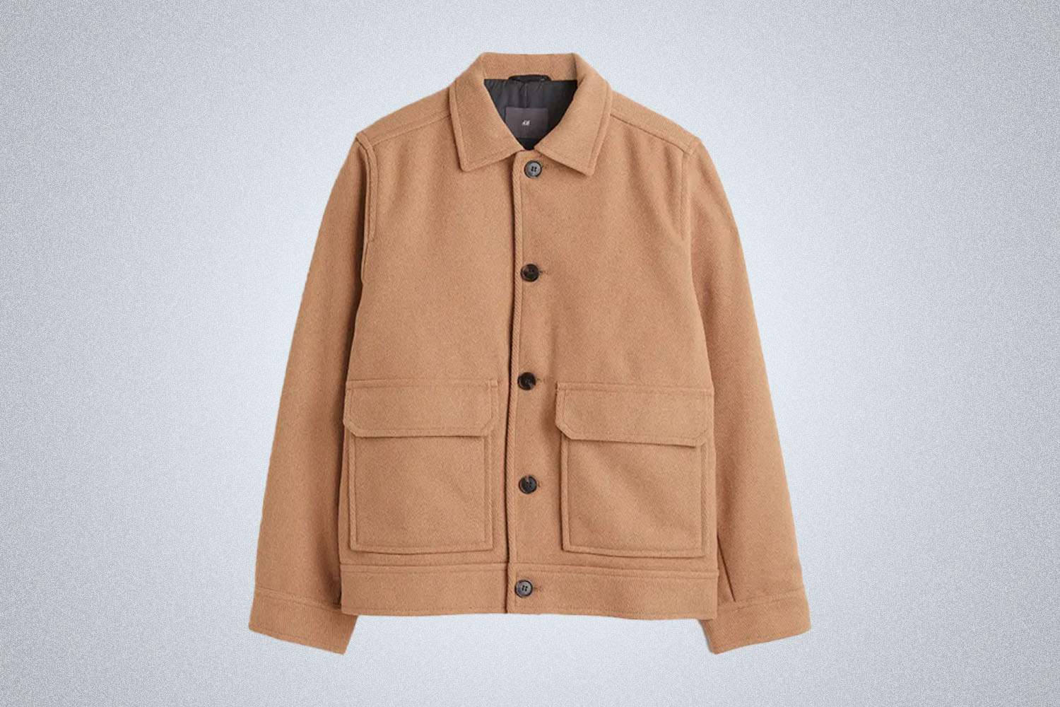 a tan wool jacket from H&M on a grey background
