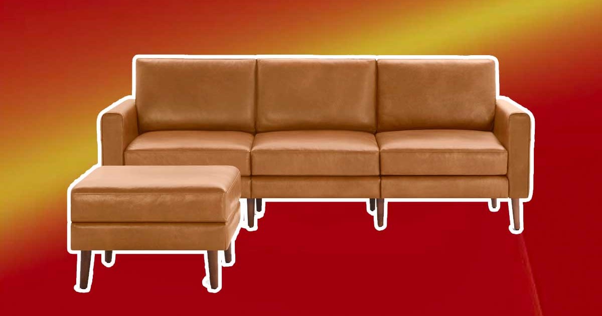 Burrow's leather Nomad sofa and ottoman on a red background