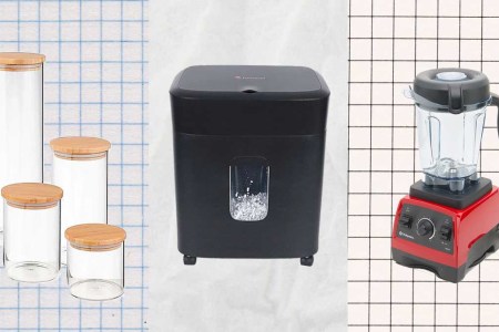 Glass jars, a paper shredder and a Vitamix blender on a paper background.