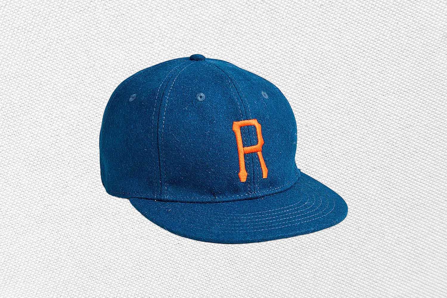 a blue wool baseball cap from J.Crew on a grey background