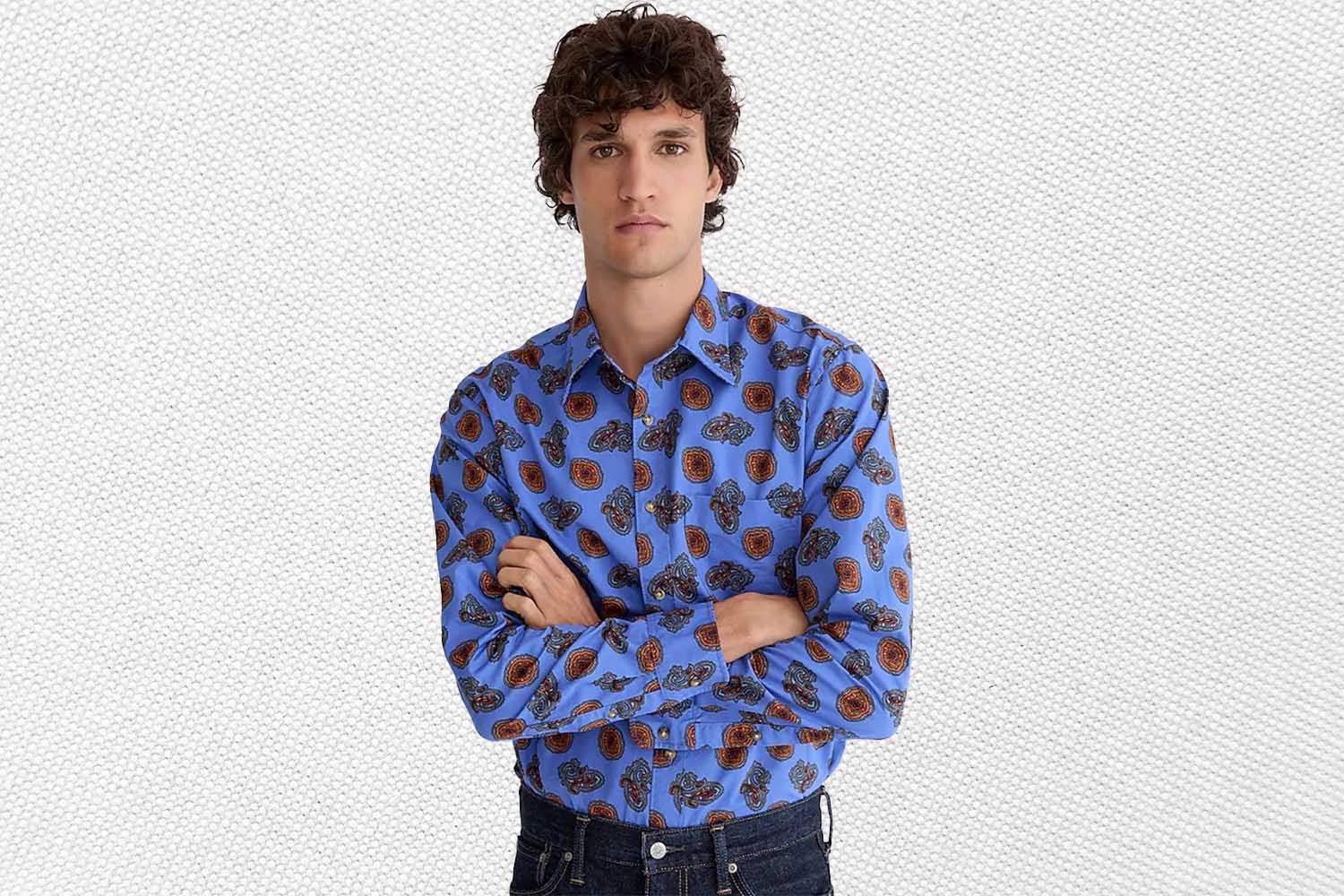 a model in a light blue paisley printed shirt from J.Crew on a grey background