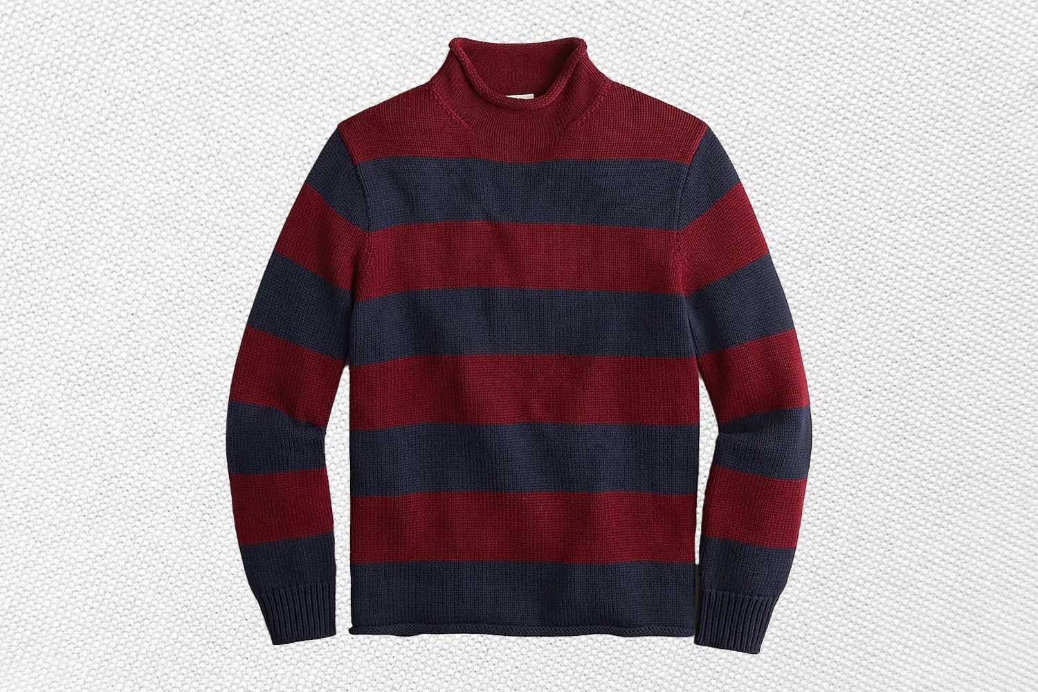 a blue and maroon striped rollneck sweater from J.Crew on a grey background