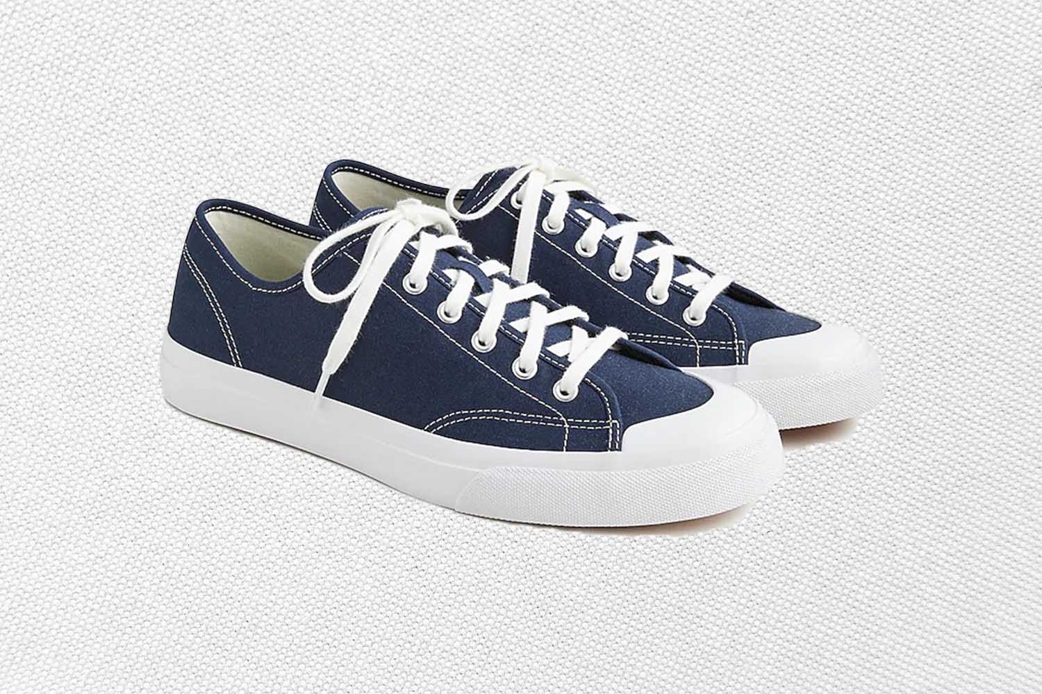a pair of white soled blue sneakers from J.Crew on a grey background